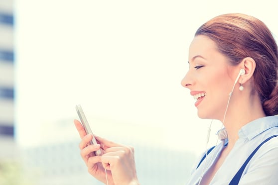 Lady laughing and staring at her phone.